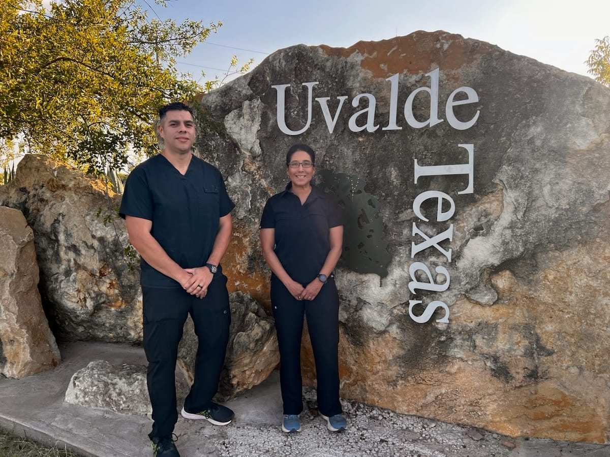 Image of founders standing together in front of a large rock background with Uvalde, Texas on it.